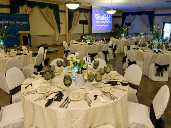 Photo of tables set up for a formal dinner inside the Scanlon Banquet Hall