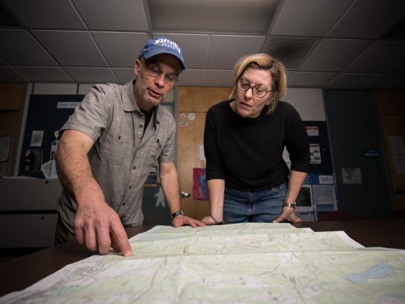 Professor Carsten Braun works along side a student as they review map features in class