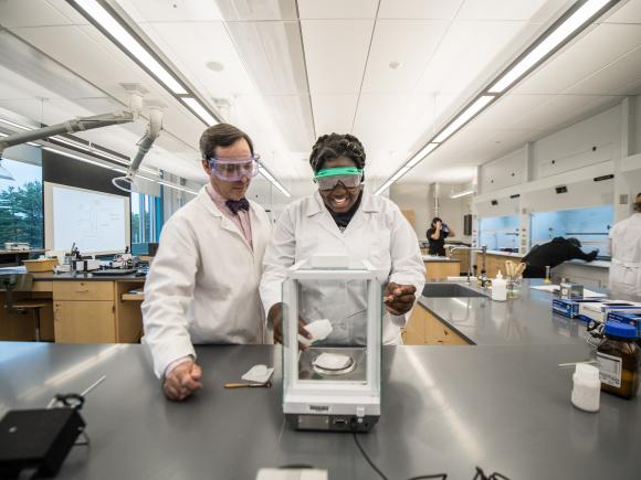 Dr. Chris Masi assists one of his students measure a sample in a Stevens Center lab