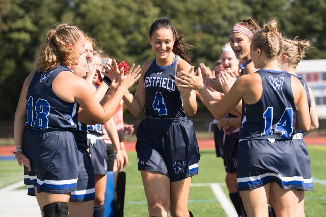 Westfield State field hockey players high-fiving before a match