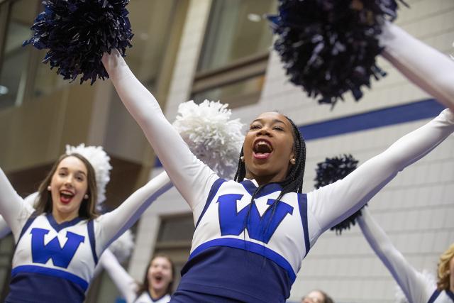 Photo of Westfield State cheerleaders cheering during a game in the Woodward Center