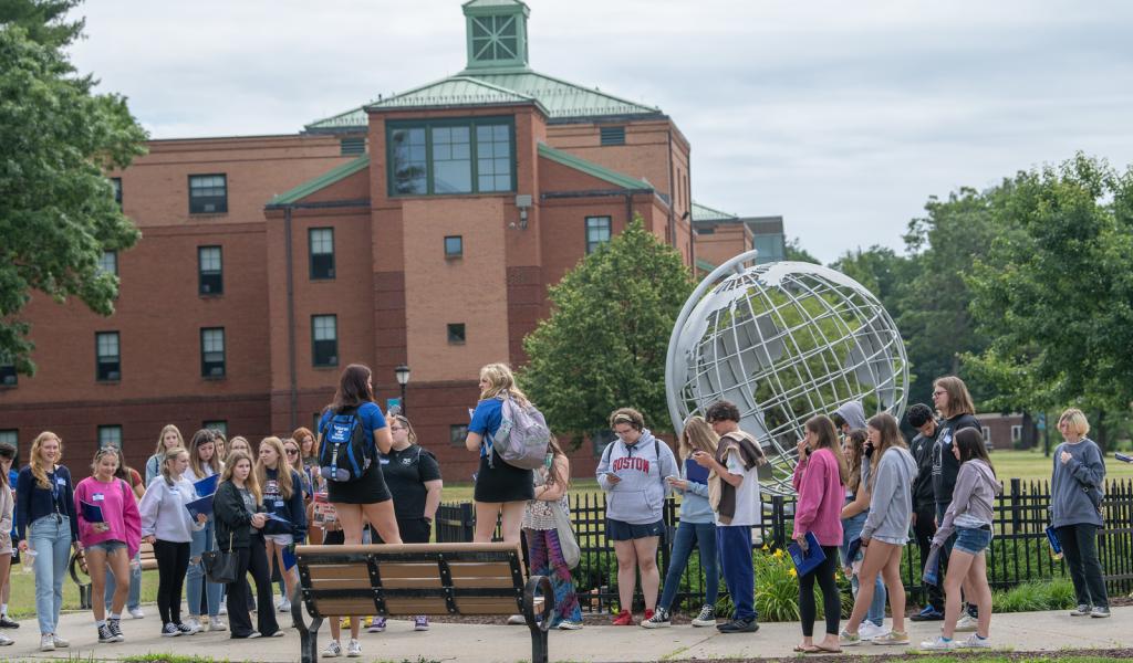 New Student Orientation group standing outside in front of campus globe