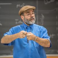 Professor Aaron Reyes teaching in classrooom.