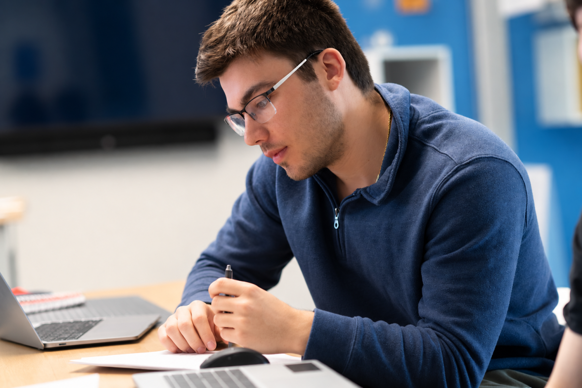 Student working on a laptop in a classroom.