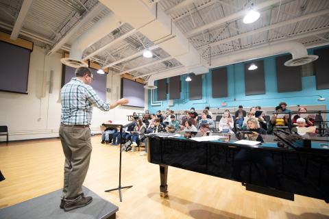 Director Scott Bailey reviews music with the Westfield State University Chorus during a rehearsal at the Dower Center.