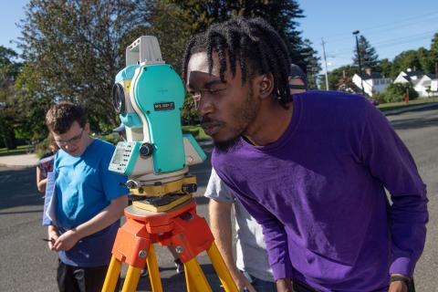 Westfield State Students survey a parking lot in town.