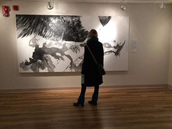 A visitor to the Arno Maris Gallery stands before a painting