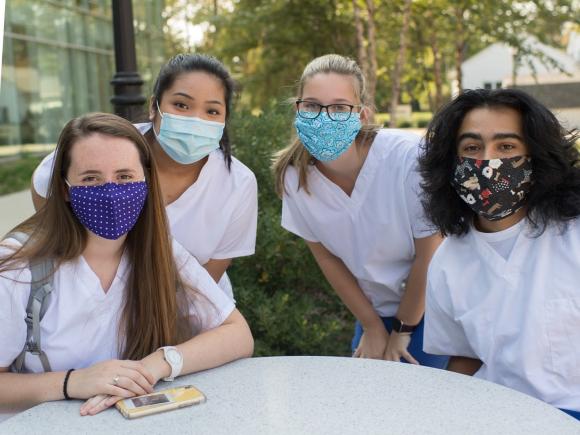 Masked nursing students outside the Stevens Center