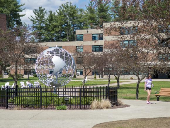 Globe on the campus green with Lammers Hall in the background