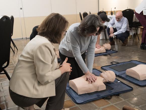 People performing CPR on a dummy