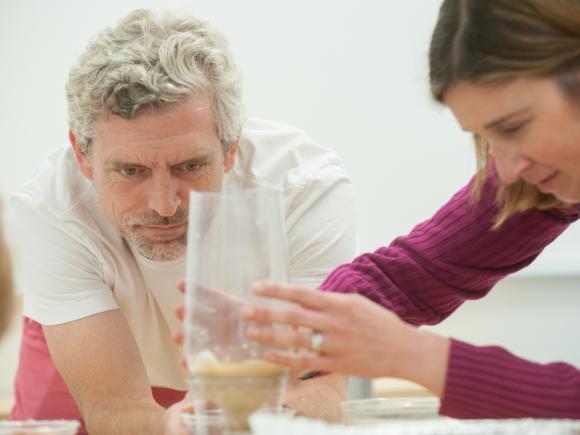 Two local educators assemble a hydrosphere during a professional development seminar