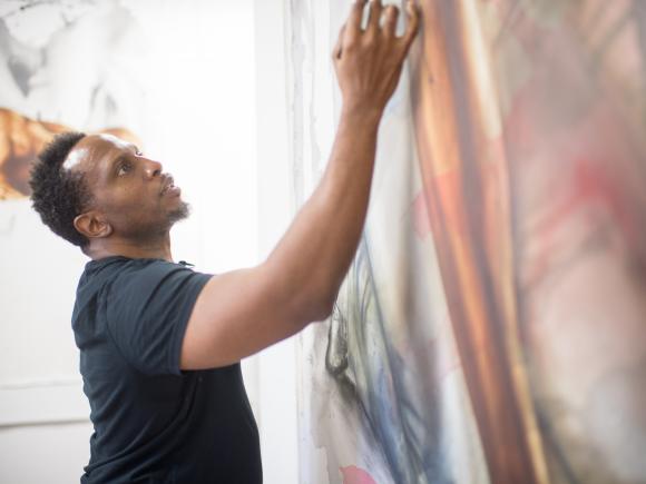 Art professor, Imo Imeh, working on one of his large canvases in his studio