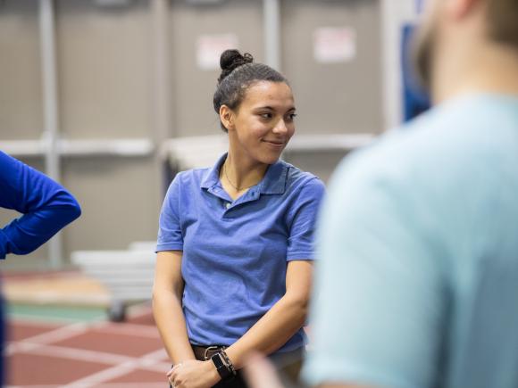 female movement science student smiles during class