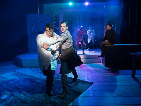 Two students, in costume, Dance the tango on stage during a theatrical performance in the Ely Black Box