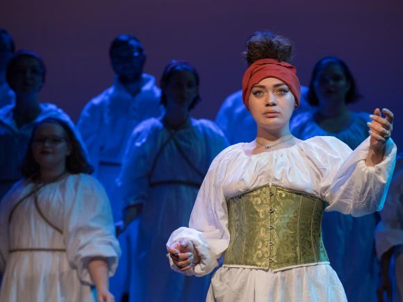 A female music student, in costume, performs during The Music Department's Opera Night