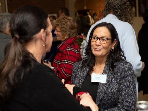 Westfield State Associate Dean Rebecca Morris and Trustee Landrau enjoy conversation at the 2022 holiday reception following a Board meeting.
