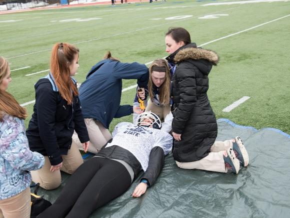 WSU students practicing emergency response in real-world scenarios such as an injured athlete.
