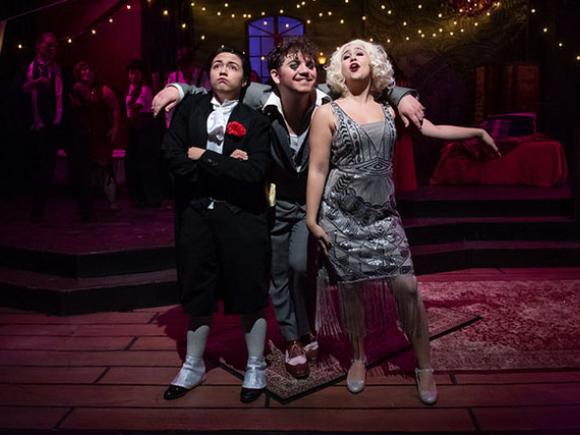 Three students in costume in a performance of “Wild Party.”