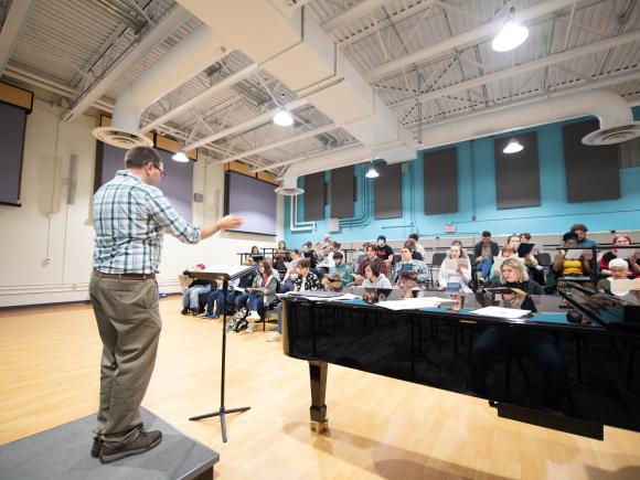 Director Scott Bailey reviews music with the Westfield State University Chorus during a rehearsal at the Dower Center.