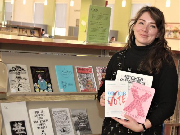 Anna Boutin-Cooper, research and instruction librarian at Westfield State University, holds some examples of zines that are part of the university collection.