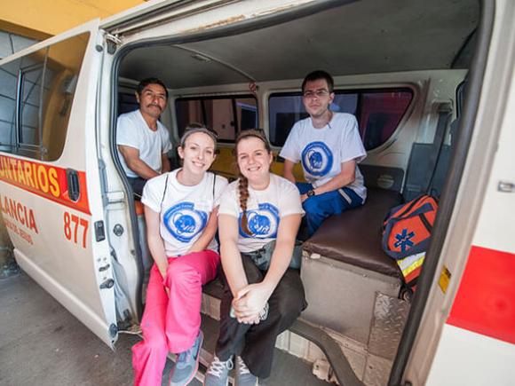 Westfield State nursing students sit inside a local ambulance in Sacatepéquez, Guatemala