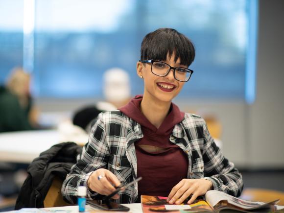 Young women at table smiling