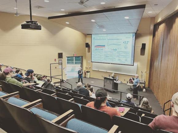 A professor displays a presentation to a room full of students.