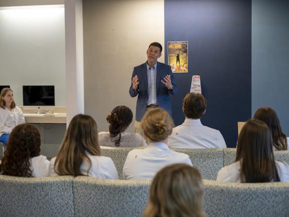 John Velis addresses a crowd of students.