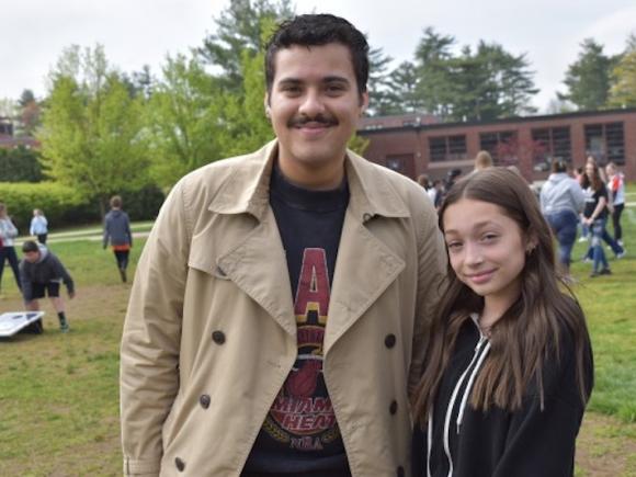 (From left to right): Joseph Bonilla, a junior at WSU, and Mia Burkhead, from Westfield Middle School pose side-by-side while outdoors and surrounded by peers.