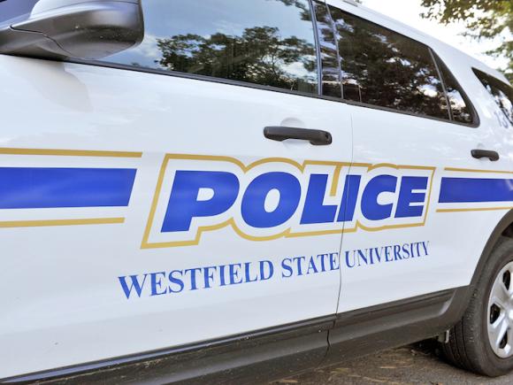 A close-up of a police cruiser, with "POLICE: Westfield State University" in blue text on its side.