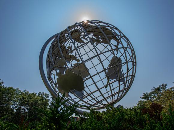 A photo of the University's globe against a blue sky.