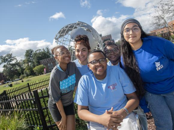 Photo of five TRIO students by campus globe smiling