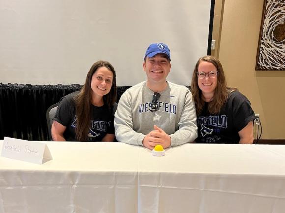 Taylor Saimeri, Jennifer Petrucci, and Andrew Allard sit behind a white table as they prepare to compete at the 2023 MAPA Challenge Bowl Competition.