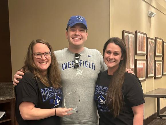 Taylor Saimeri, Jennifer Petrucci, and Andrew Allard wear Westfield State T-shirts and hold the trophy they won for the 2023 MAPA Challenge Bowl Competition.