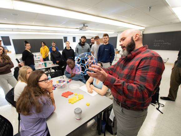 Alex Moore teaching students in a classroom