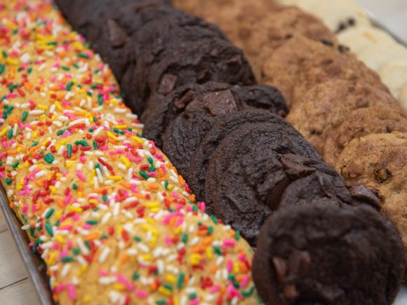 Rainbow sprinkle sugar cookies, chocolate chunk cookies, and chocolate chip cookies.