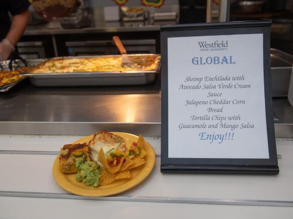Dining services global menu featuring shrimp enchilada with avocado salsa, cheddar cornbread, and mango salsa.