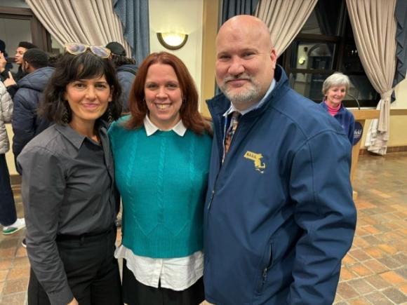 Sophia Tatiana Sarigianides, Rebecca Ashley, and Jeffrey Riley, Commissioner of Education in Massachusetts standing next to each other and smiling, as part of the The Impact of Learning about Social Class in Twelfth Grade ELA on campus.