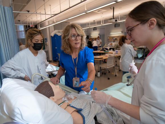 WSU Nursing faculty Jean Prast, works with students in the SIM lab