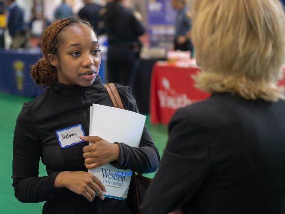 Student at Criminal Justice Fair speaking with an employer.