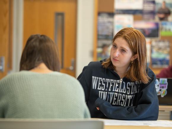 Student in history class wearing blue WSU sweatshirt with brown shoulder length hair.
