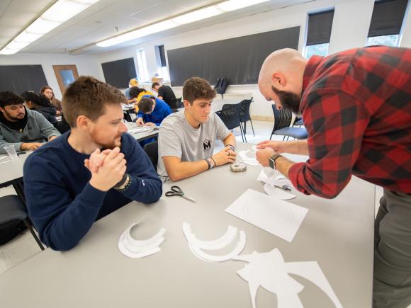 Mathematics class featuring a faculty member working interactively with two students 