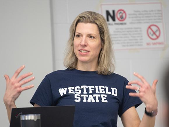 Economics Department Chair Dr. Susanne Chuku stands at the front of a classroom while teaching.