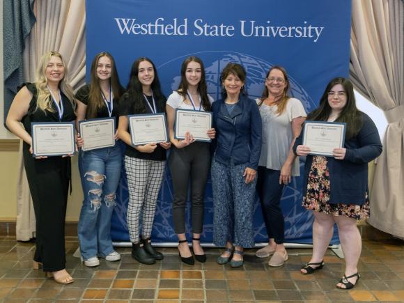Psychology students with faculty member at Academic Awards Ceremony.