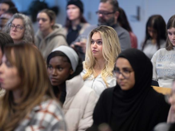 Crowd sits in a lecture