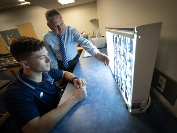 Student and faculty member reviewing imaging in an athletic training class.