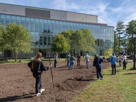 Students and faculty members plant a meadow outside Nettie Stevens Science Center