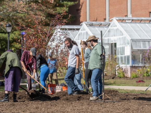 Students and faculty plant a meadow outside the Wilson Greenhouse