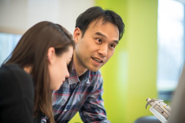 Professor Mao-Lun Weng works with students in one of the labs in the Stevens Center