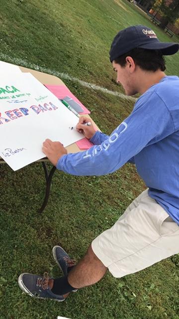 Student Signs DACA Poster